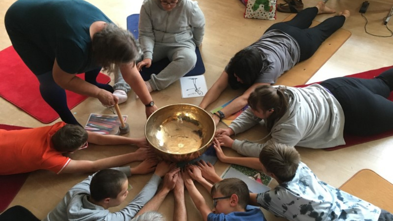 Schüler*innen liegen auf dem Bauch auf dem Boden 