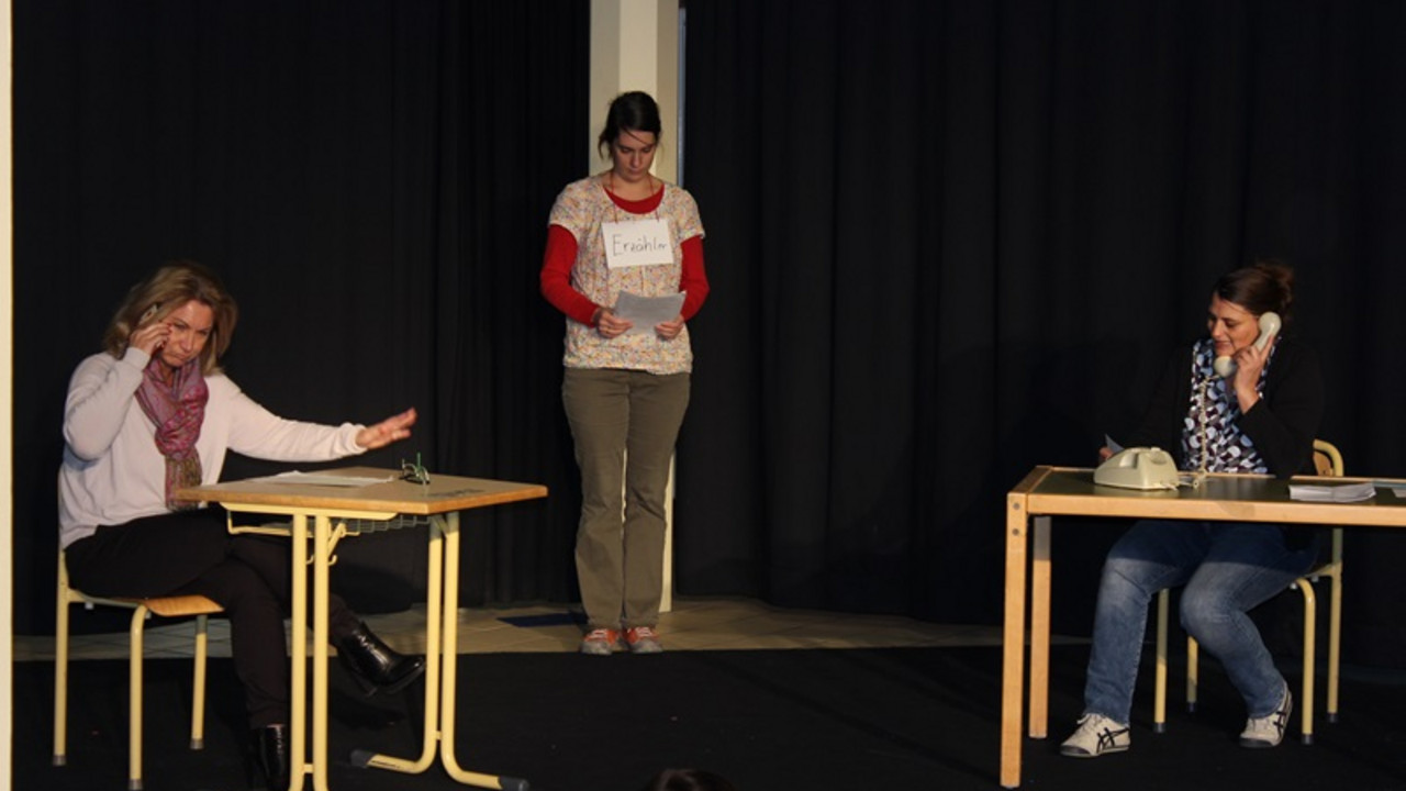 Lehrer stehen auf der Bühne und spielen ein Sketch vor