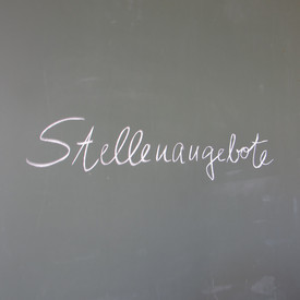 Schriftzug Stellenangebot mit weißer Kreide auf Schultafel