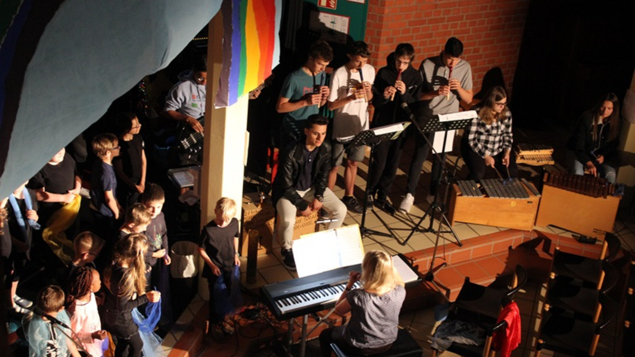 Schülerinnen und Schüler spielen ein Instrument