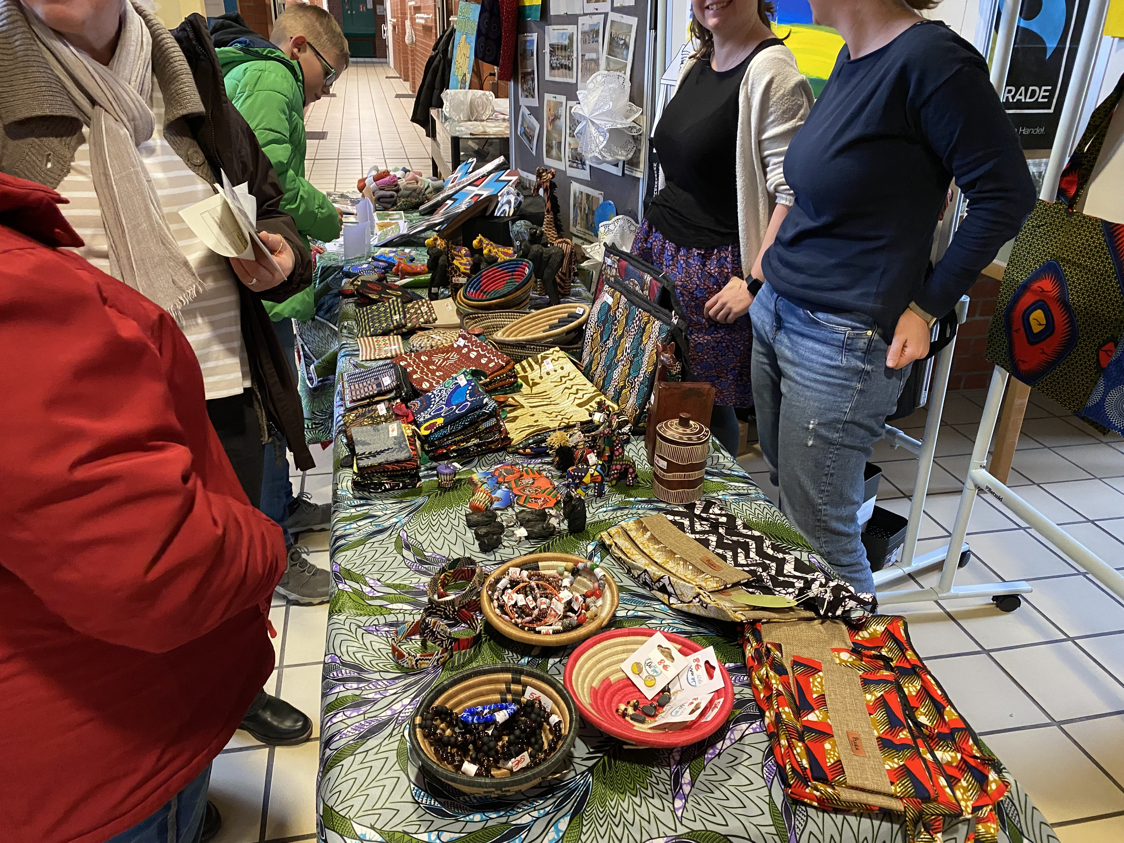 Selbstgenähte Taschen, Kulturbeutel mit Stoffen aus Ruanda und sonstige Geschenkartikel, wie Schlüsselanhänger aus Ruanda auf einem großen Tisch